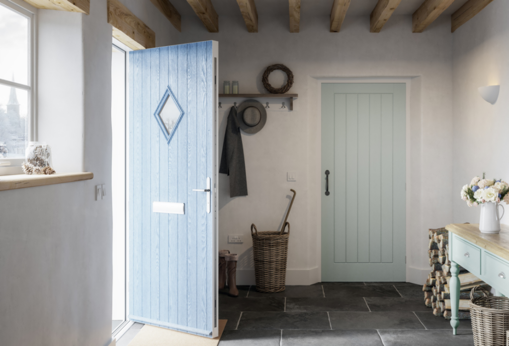 An open blue composite door leading outside, and a closed mint green door inside a rustic entryway with wooden beams, slate floor, and country-style décor.